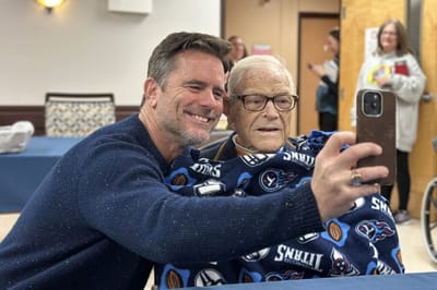 Resident and staff member taking a selfie together.