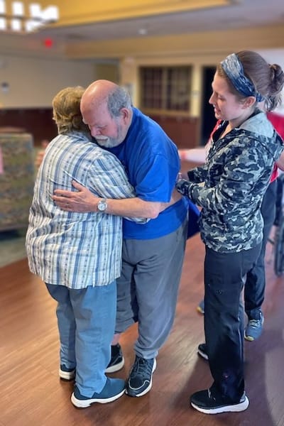 Staff assisting residents during a group activity