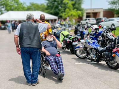 Residents enjoying an outdoor motorcycle event.