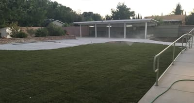 Outdoor space with grass and covered area.