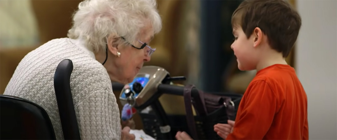Elderly woman interacting with a young boy.