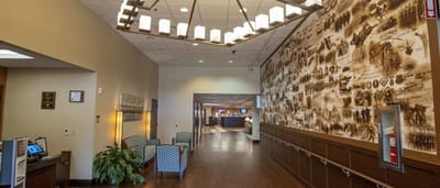 Welcoming lobby with seating and a mural.