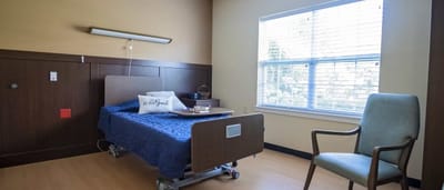 Cozy resident room with bed and chair