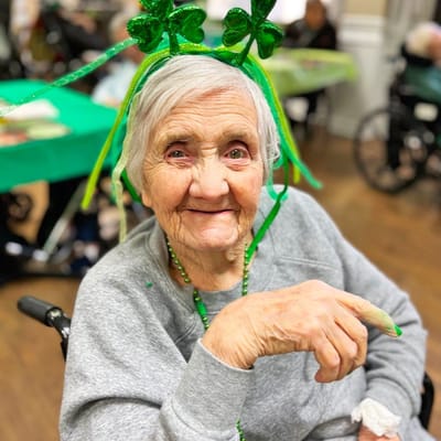 Elderly resident celebrating at a festive event.
