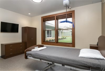 A private resident room with a bed and window.