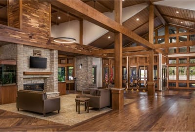 Common area with seating and stone fireplace.