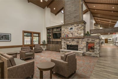 Cozy interior common area with seating and fireplace.