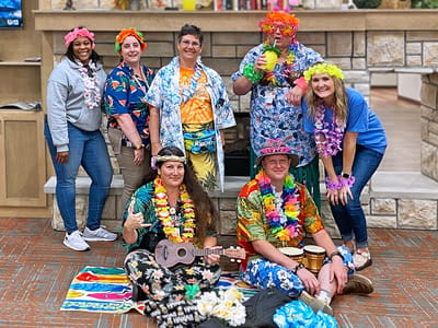 Residents and staff celebrating in colorful attire