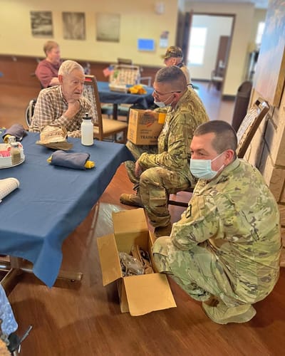 Veterans engaging with staff in a social setting.