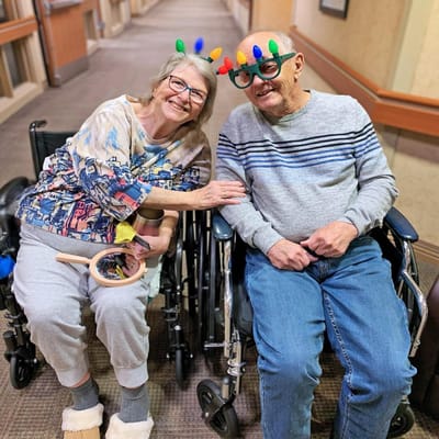 Residents enjoying a joyful moment in wheelchairs.