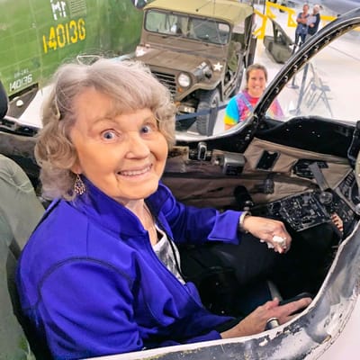 Senior resident enjoying an aircraft cockpit experience.