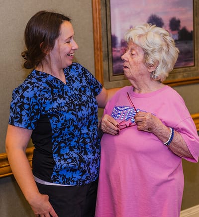 Staff member engaging with resident in a common area.