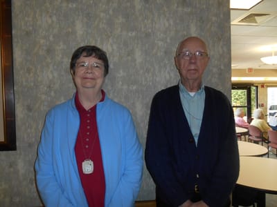 Two residents posing in a common area