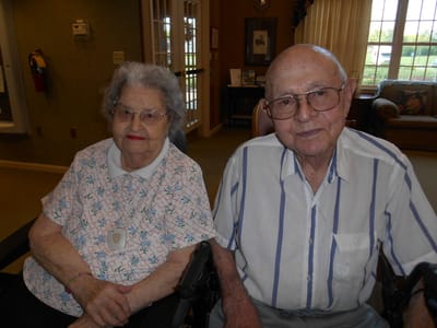 Two residents sitting together in a common area.