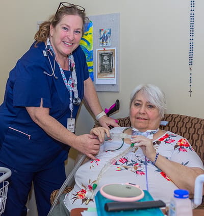 Healthcare worker assisting a resident with care.
