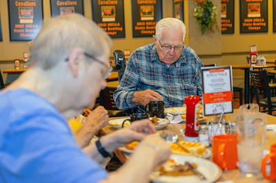 Residents enjoy a meal in the dining room.