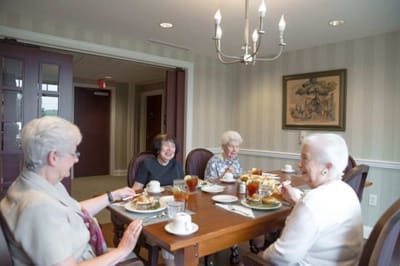 Residents enjoying meals together in a dining room