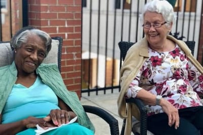 Two smiling residents enjoying the outdoors