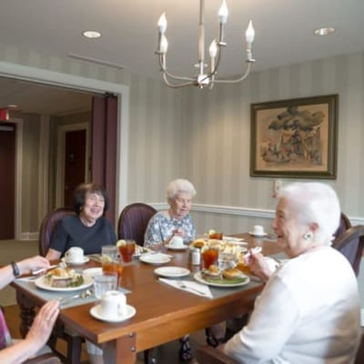 Residents enjoying a meal together in a dining room.