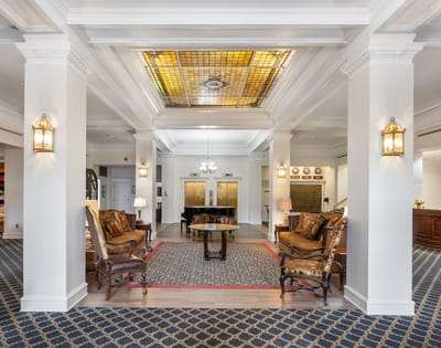Elegant lobby with seating and decorative ceiling