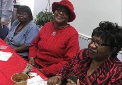 Three residents enjoying time together indoors.