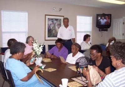 Residents engaged in a bingo game in a common area.