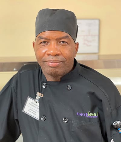 Kitchen staff member in a chef uniform.