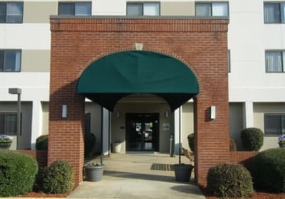 Entrance of assisted living facility with green awning