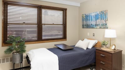 Cozy resident room with a bed and window.
