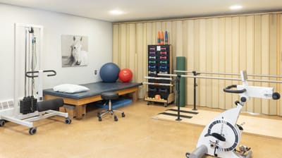 Rehabilitation gym area with exercise equipment