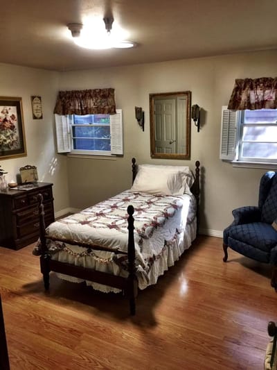 Cozy resident room with a bed and chair