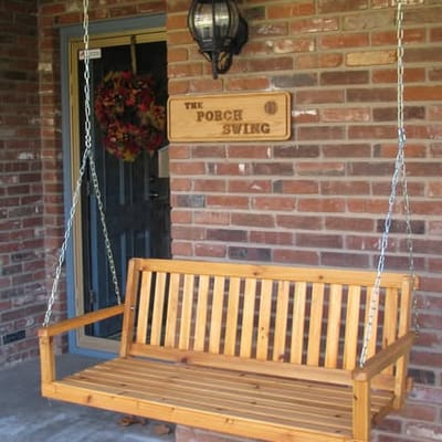 Wooden porch swing in a welcoming entryway