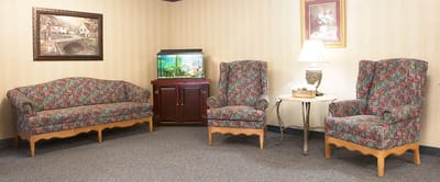 Seating area in a common room with floral couches