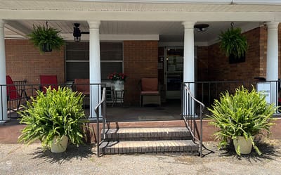 Entrance with greenery and seating area