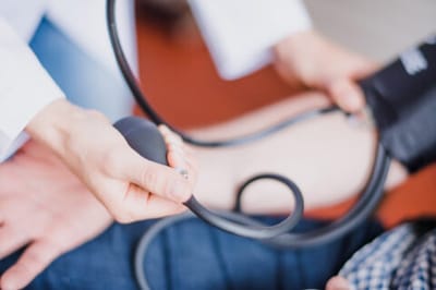 Medical professional checking a patient's blood pressure