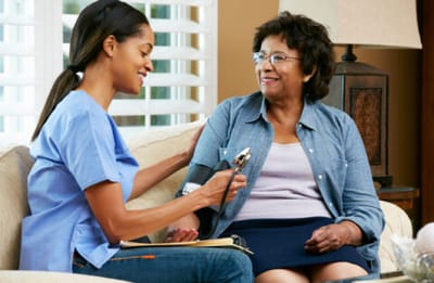 Nurse checking blood pressure of a resident