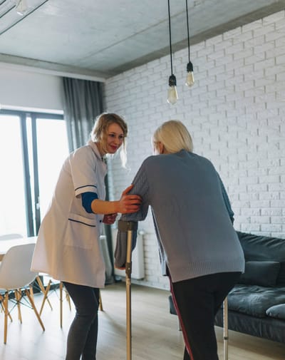 Healthcare professional assisting a resident indoors