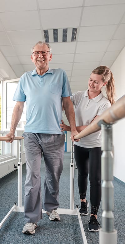 A staff member assists a resident during therapy