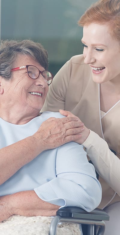 Senior resident enjoying a conversation with a staff member