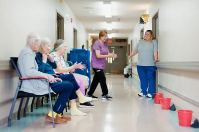 Residents engaging in an activity with staff support