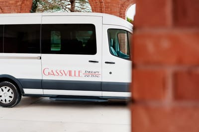 Facility transport van parked at the entrance