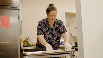 Staff member preparing food in a kitchen