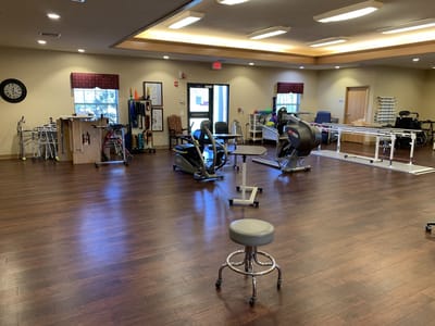 Activity room with fitness equipment and therapy tools