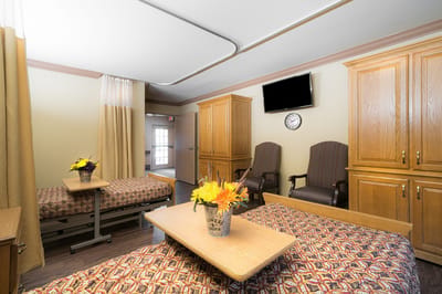 Bright shared bedroom with two beds and flowers