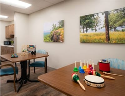 Bright activity room with musical instruments and art
