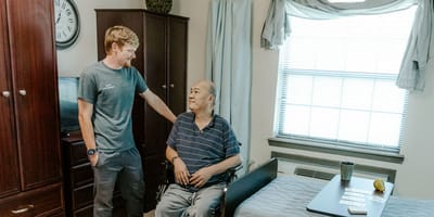 Staff member interacting with a resident in a cozy room