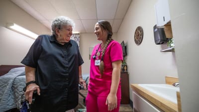 Staff member engaging with a resident in a room
