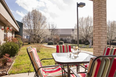 Outdoor patio area with seating and flowers