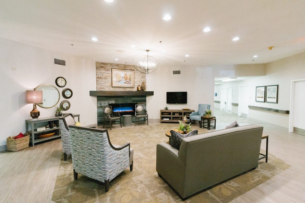 Bright common area with comfortable seating and a fireplace