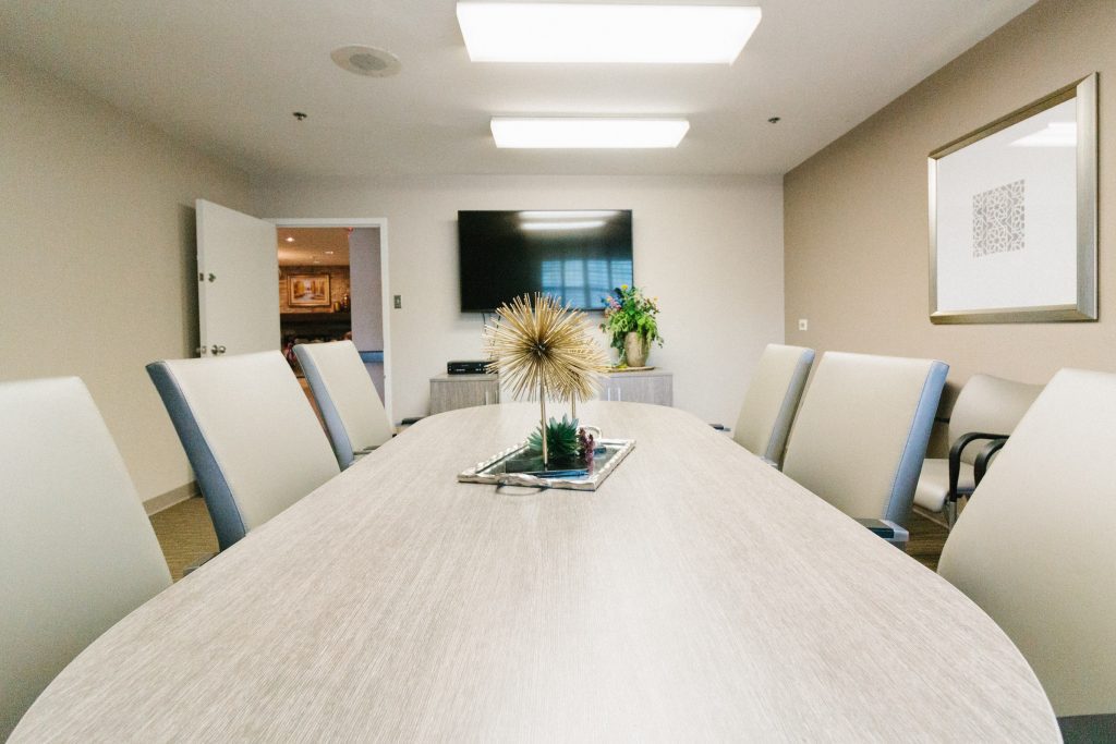 Modern conference room with a large table and plant decor